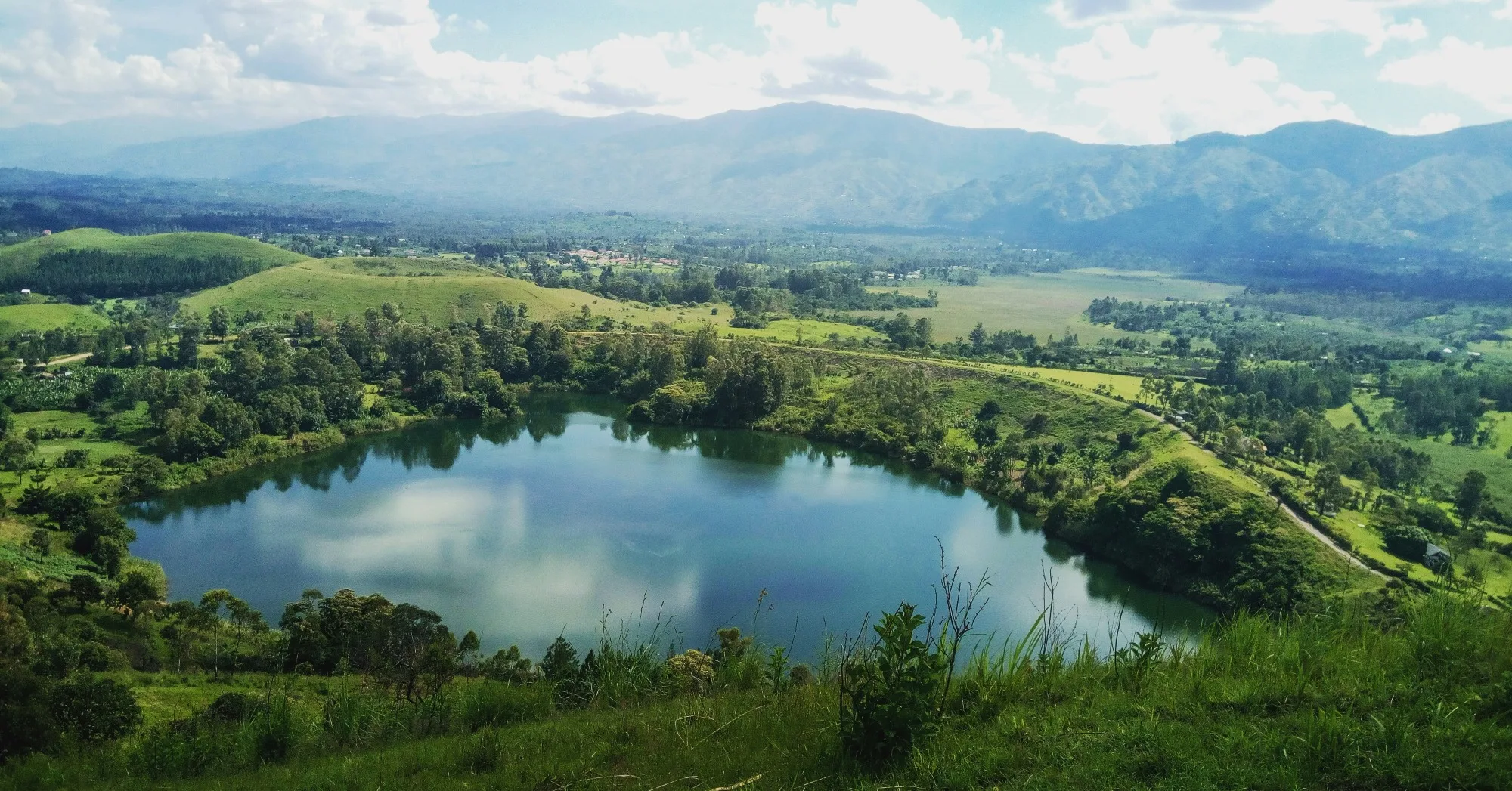 Mist-covered rainforest and green hills in southwestern Uganda
