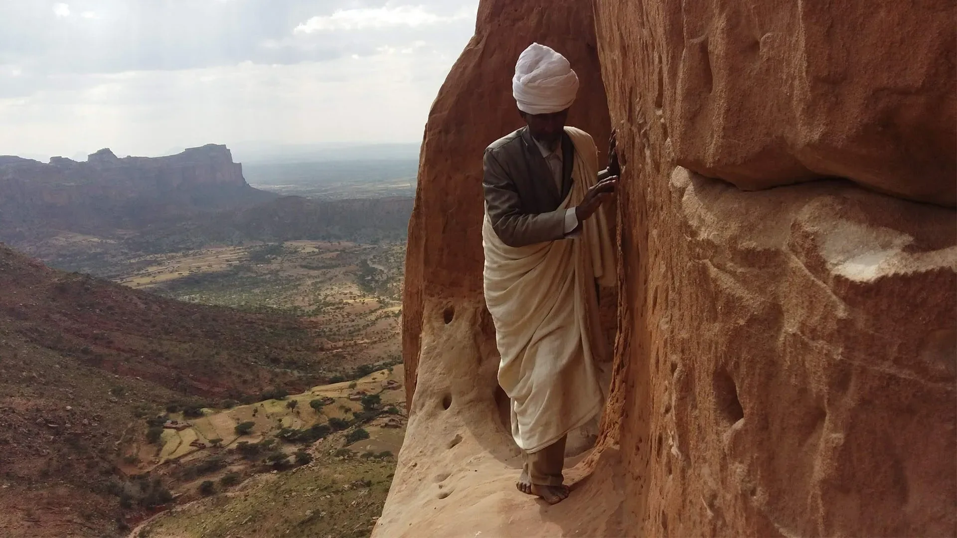 Visitor approaching Abuna Yemata Guh church in the Tigray highlands of Ethiopia